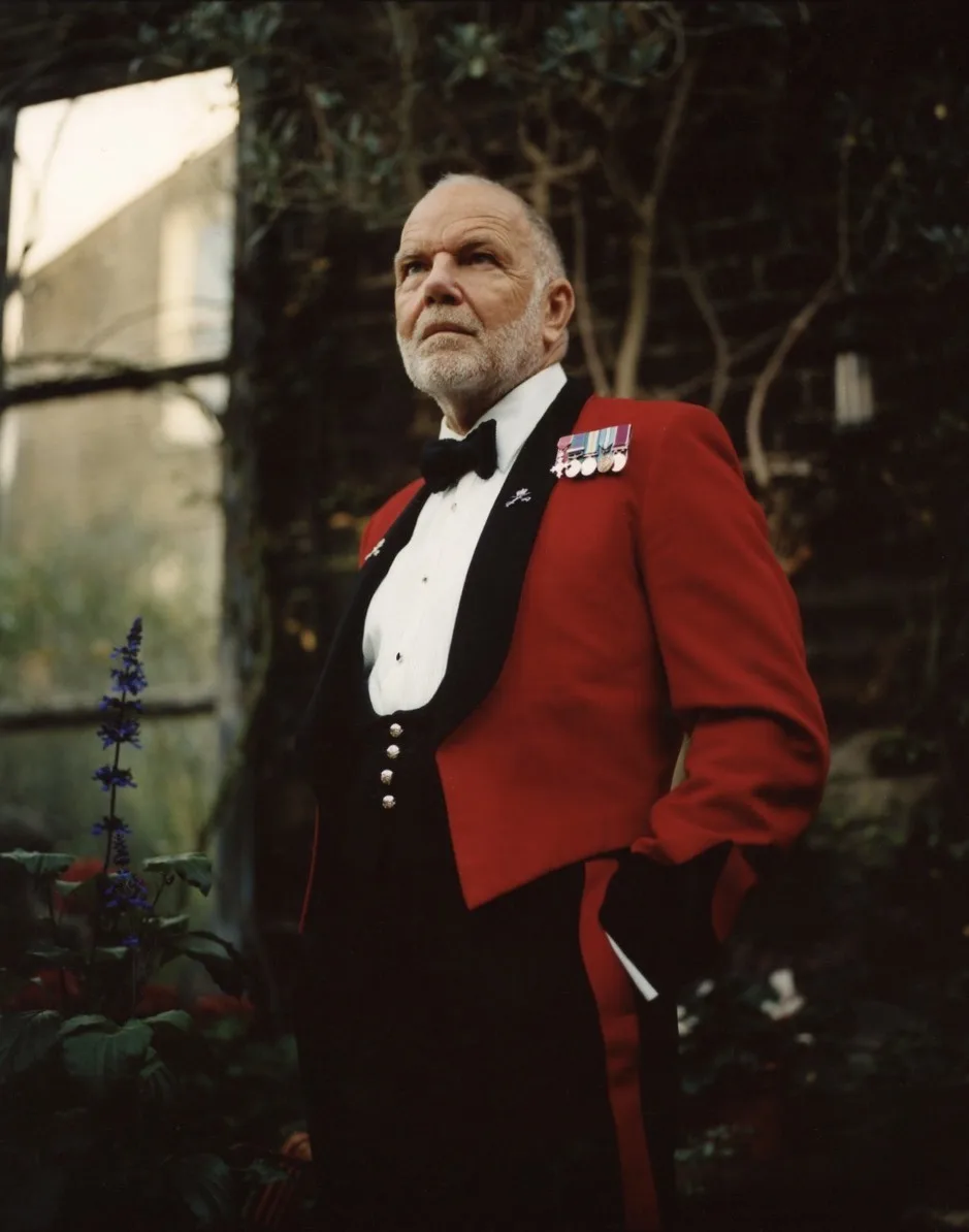 Revd Paul Cowley MBE in scarlet Army mess dress, wearing his medals